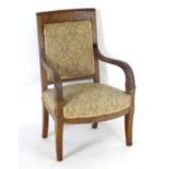 A 19thC Empire style mahogany chair with reeded arms, carved anthemion decoration and raised on