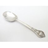 A silver teaspoon with scroll decoration and rat tail to bowl. Hallmarked Sheffield 1979 maker