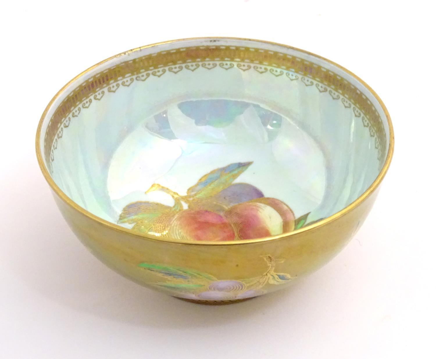 A Wedgwood lustre ware bowl with hand painted fruit decoration with gilt highlights. Approx. 2 1/
