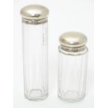 Two silver lidded glass dressing table / vanity bottles. Both hallmarked London 1896 maker WHW.