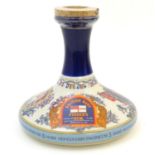 A c1980s bottle of Munson Shaw British Navy Pusser's Rum, within a Wade ceramic ship's decanter,