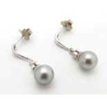 A pair of 18ct white gold drop earrings set with diamonds and pearls. Approx. 3/4" long Please