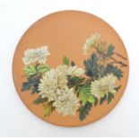 A Longpark Torquay terracotta charger with chrysanthemum flower decoration. Impressed mark and