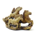 A Chinese soapstone carving modelled as three galloping horses. Incised marks under. Approx. 5" high
