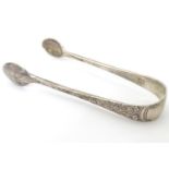 Victorian silver sugar tongs with cast floral decoration. Hallmarked London 1891 maker Wakely &