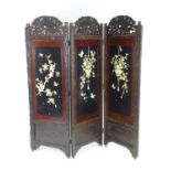 An mid 20thC dressing screen with ornately carved decoration depicting birds amongst foliage and