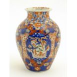 A Japanese vase of baluster form decorated in the Imari palette with floral and foliate motifs.