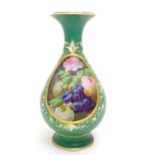 A Coalport style baluster vase with a flared rim and hand painted still life decoration to include