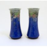 A pair of Art Deco Royal Doulton blue glazed stoneware vases of cylindrical waisted form,