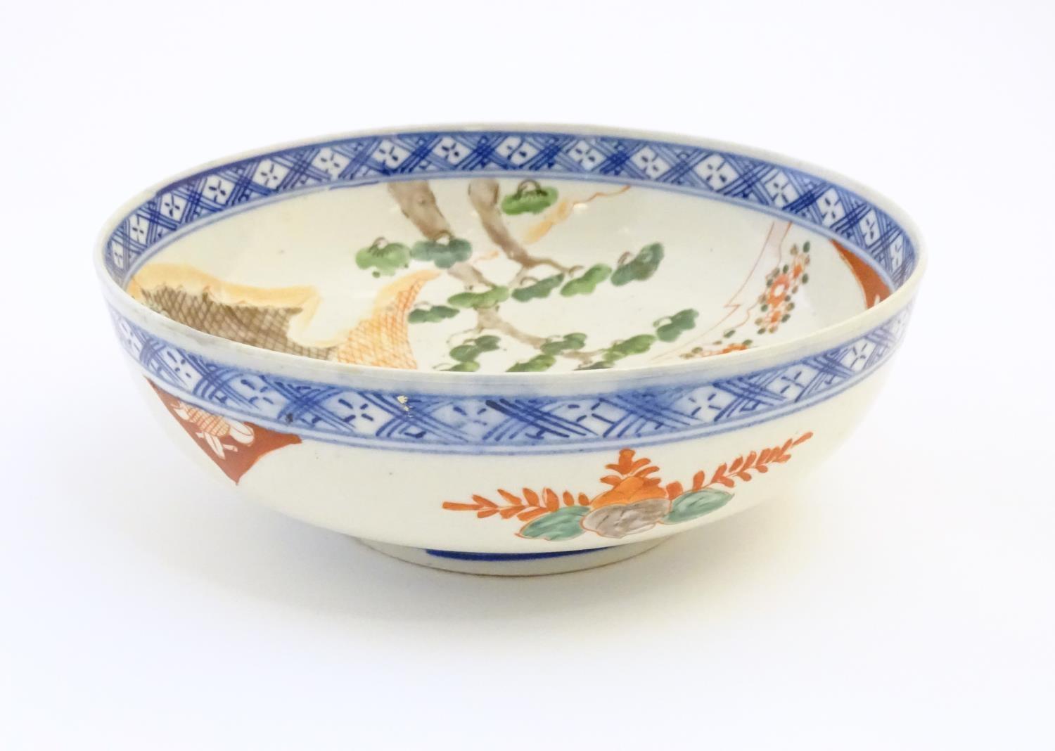 A Japanese bowl with hand painted decoration depicting a landscape scene with flowers, a crane - Image 3 of 7