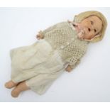 Toy: An early 20thC large composite doll with a socket head, blinking eyes, and painted features,