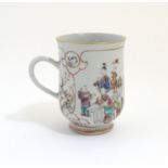 A Chinese export famille rose mug / tankard decorated with figures in a domestic interior scene, and
