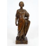 A 19thC carved walnut sculpture depicting a classical female figure with a shield, possibly Minerva,