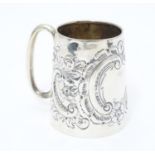 A Victorian silver christening mug with embossed decoration Hallmarked Birmingham 1898 maker Henry