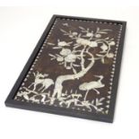 A 20thC Chinese hardwood panel with mother of pearl inlay depicting a stylised woodland scene with a