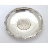 A Chinese Export silver pin dish of circular form with inset QEII Hong Kong Dollar to centre. 3 1/4"
