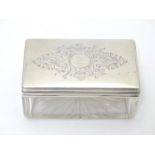 A Victorian silver topped glass dressing table box, the lid with engraved decoration. Hallmarked