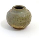 A small Chinese celadon pot with stylised leaf detail in relief. Approx. 2 1/2" high Please Note -