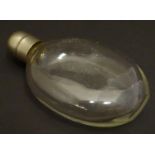 A small glass hip flask of Ovid form with screw top. Approx. 4" high Please Note - we do not make