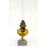 A late 19thC / early 20thC Continental oil lamp wit amber glass reservoir and clear glass chimney.