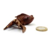 A carved netsuke modelled as a fish. Approx. 3" long Please Note - we do not make reference to the