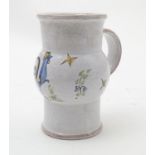 A French faience single handled vase / jug of cylindrical form with a bulbous body decorated with