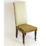 A late 19thC high back chair with turned tapering front legs and sabre back legs. Bearing metal