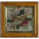 A 19thC embroidery / needlework with a still life study of shells, flowers and foliage. In a maple