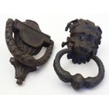 Two Victorian cast iron door knockers, one modelled as a lion head mask, the other of stylised