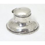 A small silver capstan shaped inkwell with hinged lid and glass liner. Hallmarked Birmingham 1938