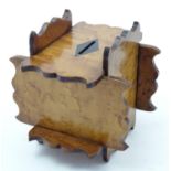 A late 19thC birdseye maple money box of unusual interlocking construction with shaped edges.