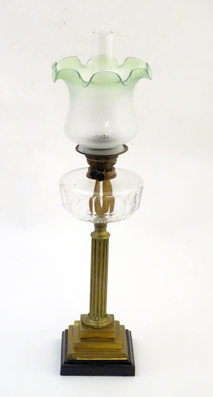 A late 19thC / early 20thC oil lamp, the brass column on stepped base supporting a clear cut glass - Image 4 of 9