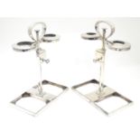 A matched pair of silver plate decanter stands / tantalus with locking mechanism to central
