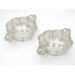 A pair of large silver bon bon / sweetmeat dishes with fret work decoration and twin handles.