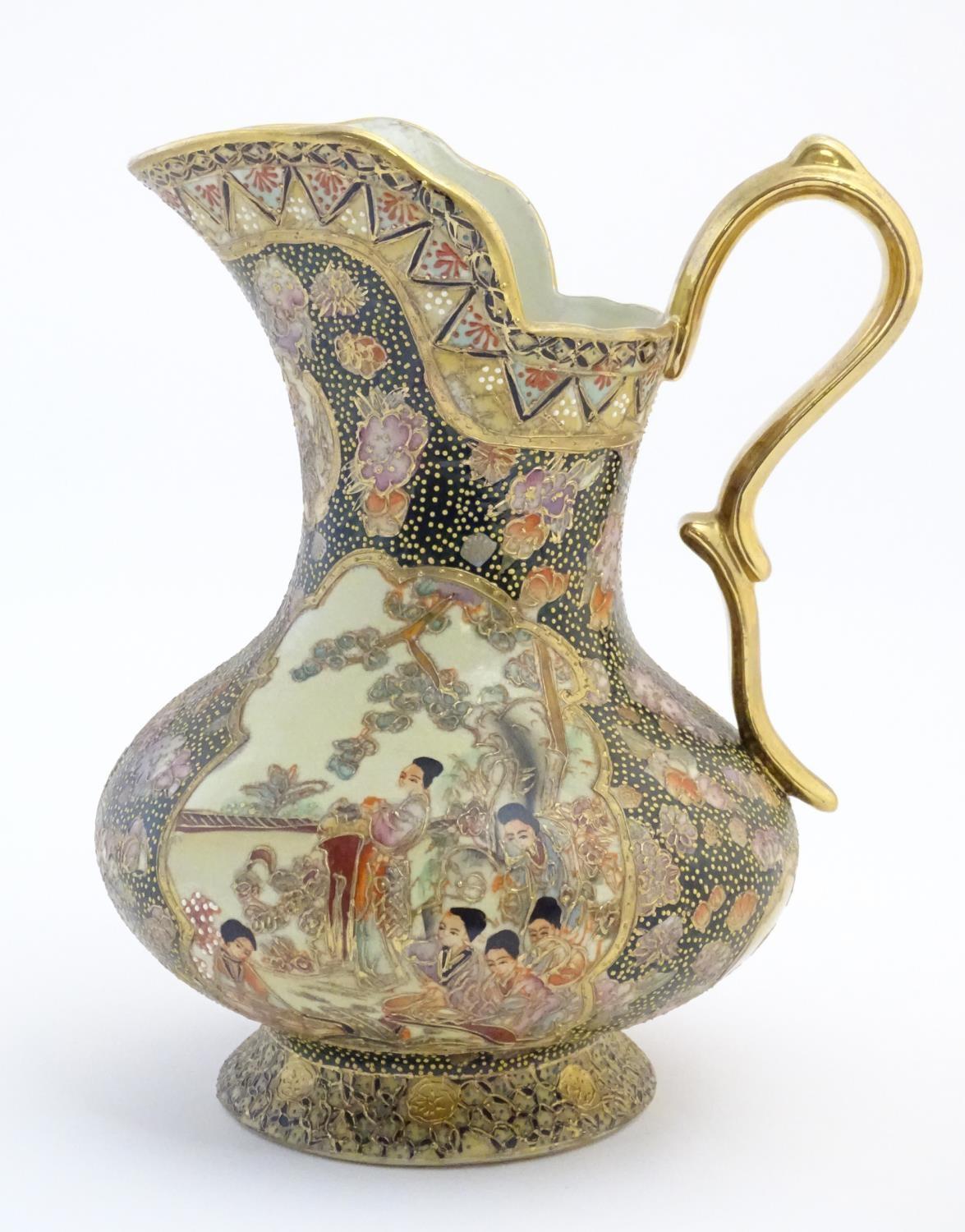 An Oriental jug / ewer with a bulbous body decorated with panels depicting ladies in a garden - Image 6 of 8