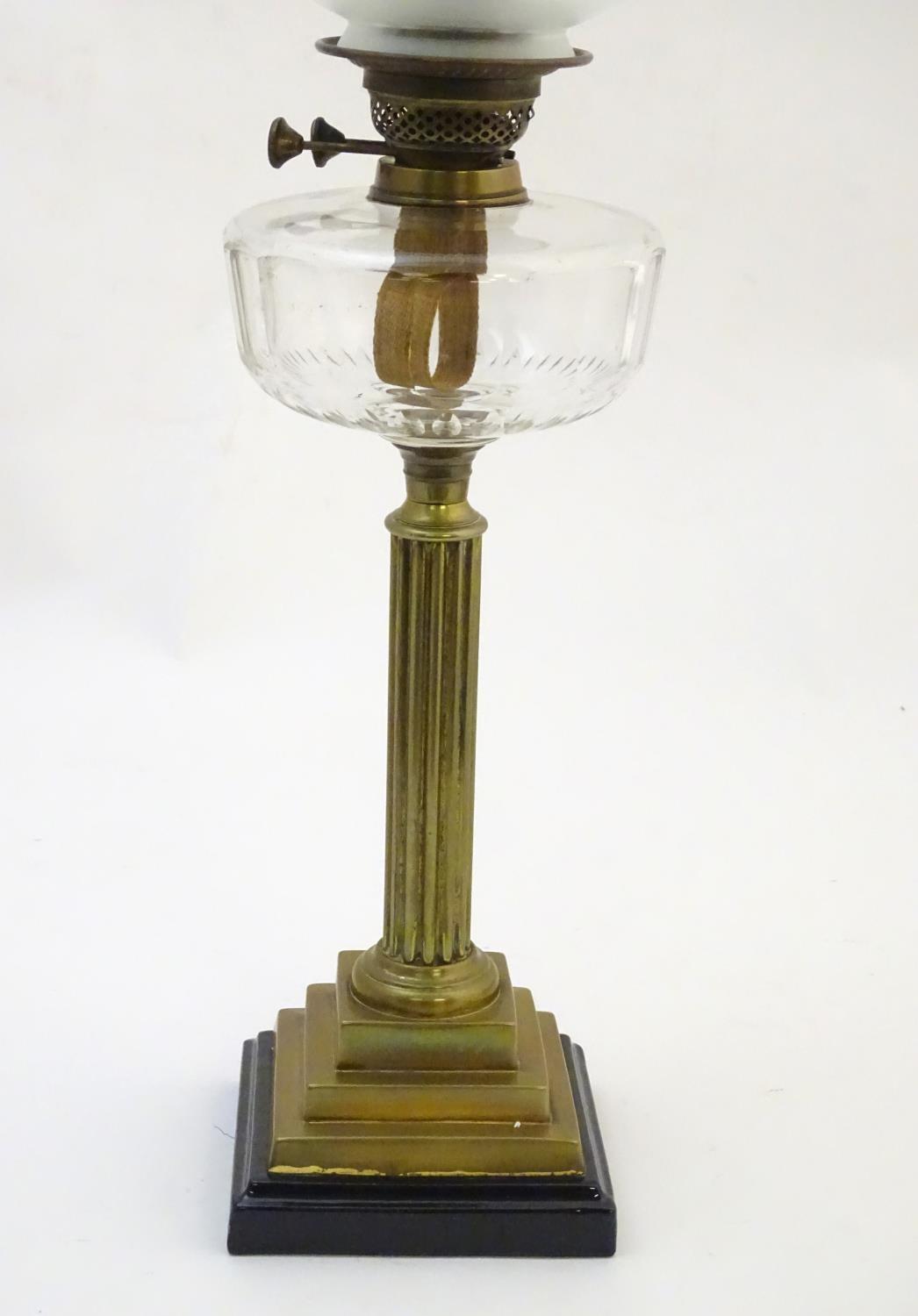 A late 19thC / early 20thC oil lamp, the brass column on stepped base supporting a clear cut glass - Image 8 of 9