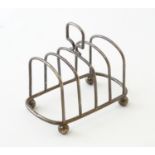 A silver five bar toast rack on four spherical feet. Hallmarked Chester 1904