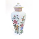 A Portuguese Vista Alegre lidded vase with hand painted floral decoration. Approx. 10 1/4" high