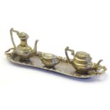 Toys: Three silver plated dolls house tea wares comprising teapot, coffee pot, sugar bowl and