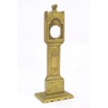 A late 19th / early 20thC brass pocket watch holder modelled as a miniature long case clock with