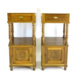 A pair of early 20thC oak bedside cabinets with marble tops above turned supports, both having