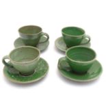 Four studio pottery cups and saucers with a green glaze. Incised maker's mark PH under. cups approx.