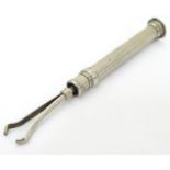 A white metal telescopic sewing tool, possibly a ribbon threader approx. 2" long (closed) Please