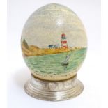 A 20thC hand painted ostrich egg depicting Mouille Point, Table Bay, South Africa, a coastal scene