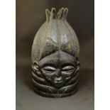 Ethnographic / Native / Tribal: A late 19th / early 20thC carved wooden Mende bundu helmet mask of