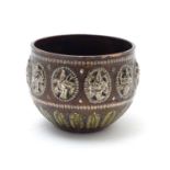A late 19th / early 20thC small Indian copper bowl with inlaid brass foliate detail and oval
