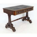 A mid 19thC mahogany writing desk with an inset top above two short drawers with turned wooden