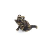 An early 20thC novelty pendant / charm cast as a seated cat. Approx. 1/2" long Please Note - we do