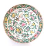 A Chinese Cantonese plate / dish decorated with birds, butterflies, flowers and foliage. Approx. 9