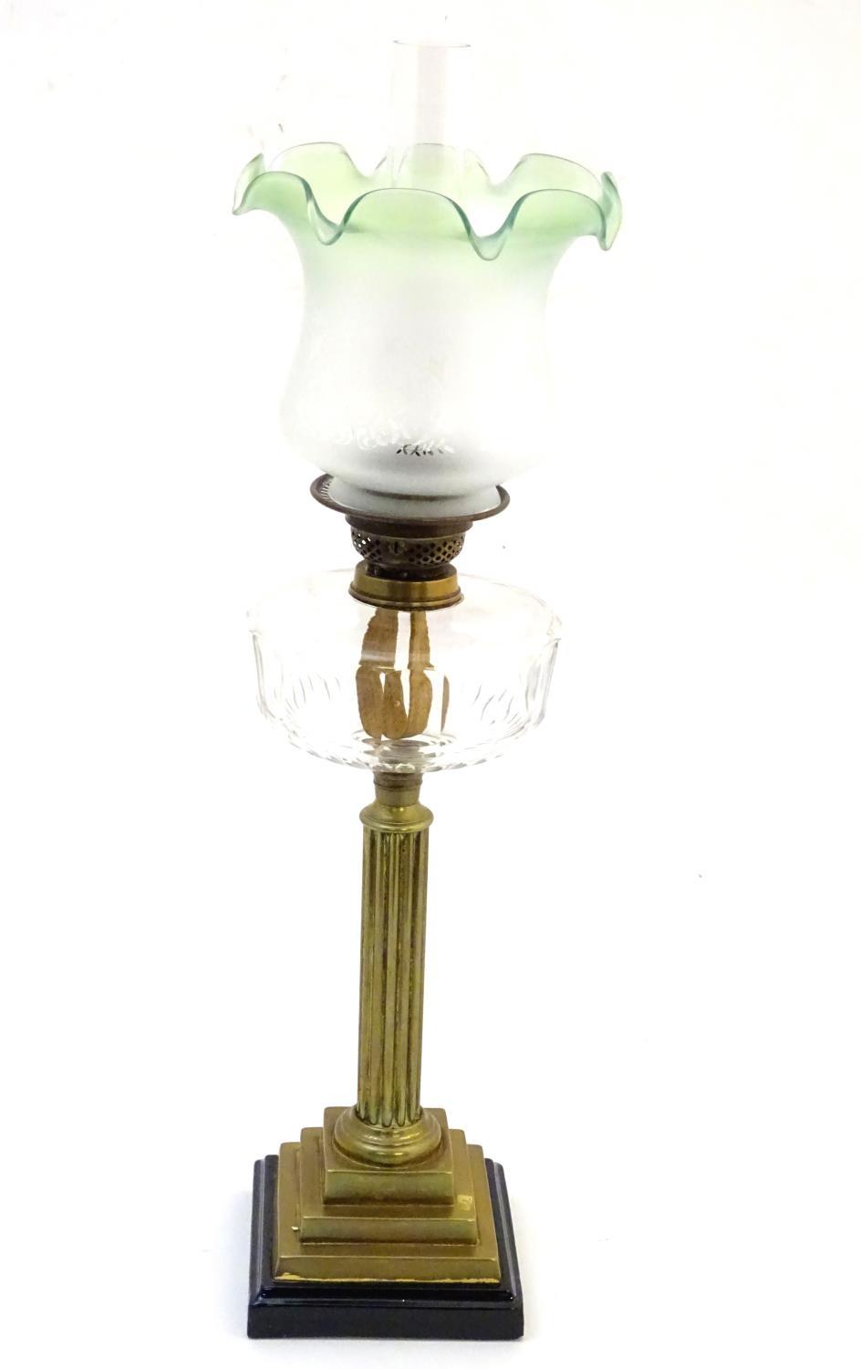 A late 19thC / early 20thC oil lamp, the brass column on stepped base supporting a clear cut glass - Image 9 of 9